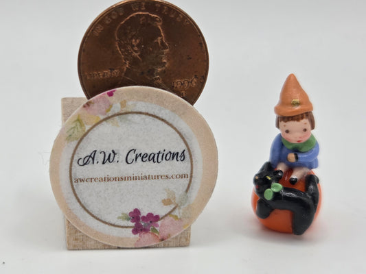 Boy on Pumpkin Figurine
