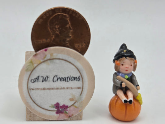 Girl on Pumpkin Figurine