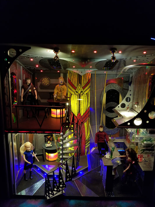 One inch scale miniature recreation of Quarks Bar on Deep Space Nine includes Star Fleet personnel, a dabo girl and an Orion slave trader. Even includes some tribbles