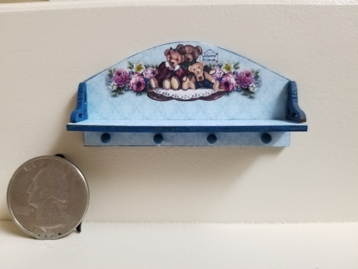 Miniature wooden peg shelf with teddy bear theme, blue with purple accents