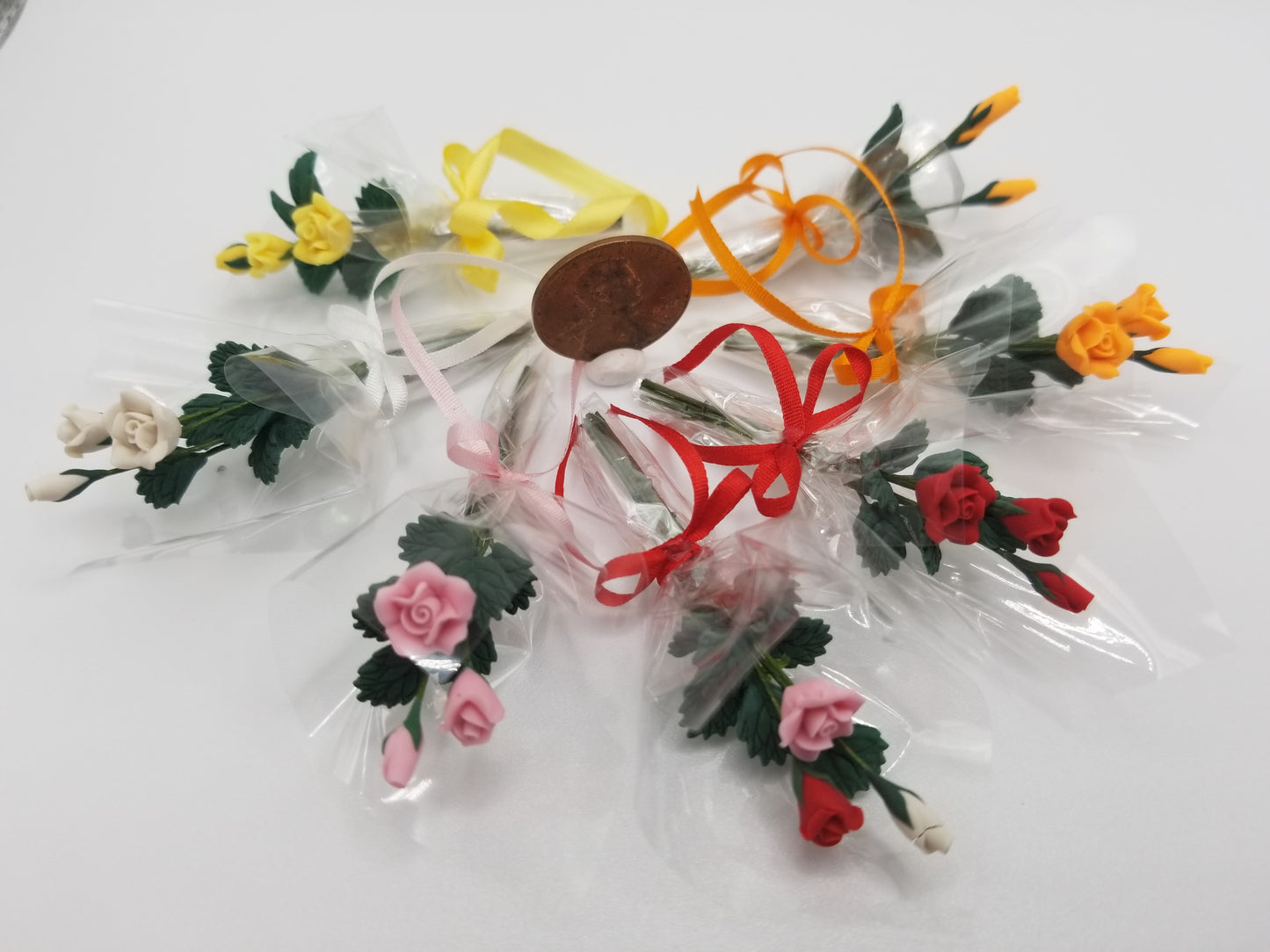 miniature dollhouse 3 clay roses wrapped in cellophane with matching bow. One inch scale 1:!2
