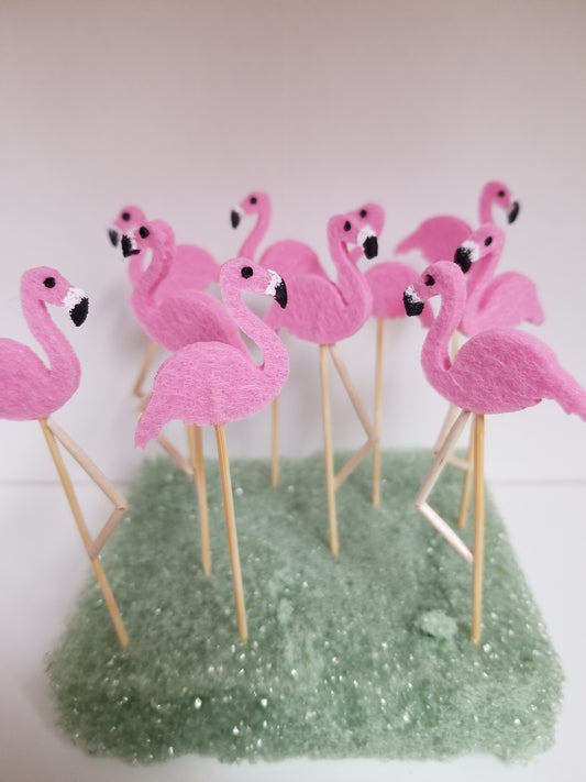 Miniature pink flamingos to decorate your yard or beach house. They are made out of thick felt. They come with a single straight leg or a straight and bent leg.